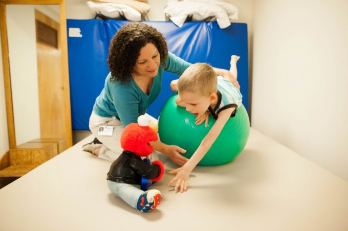 Young boy working with Physical Therapist