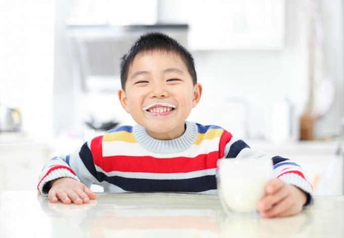Asian boy drinking milk