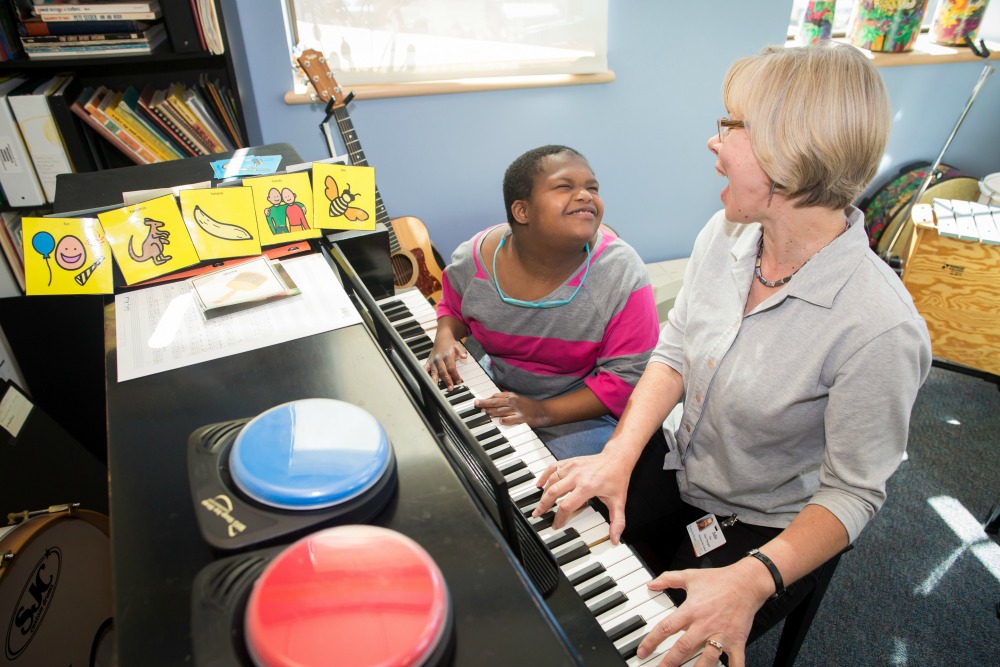 Julie, Music Therapist, working with a KDS student