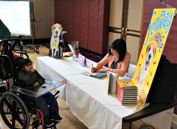 Author Victoria Coe signing copies of her book, Fenway and Hattie, for KDS students