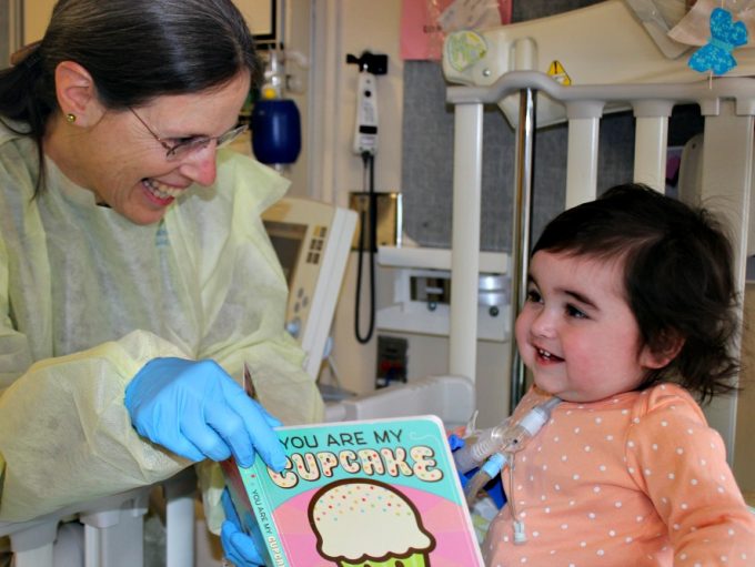 Ellen, Volunteer, works with a child in our Inpatient Pulmonary Rehabilitation Program