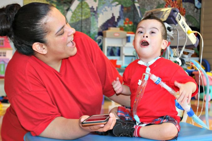 Kayden, a patient in the Inpatient Pulmonary Rehabilitation program at Franciscan Children's sings a song with his mom in the playroom